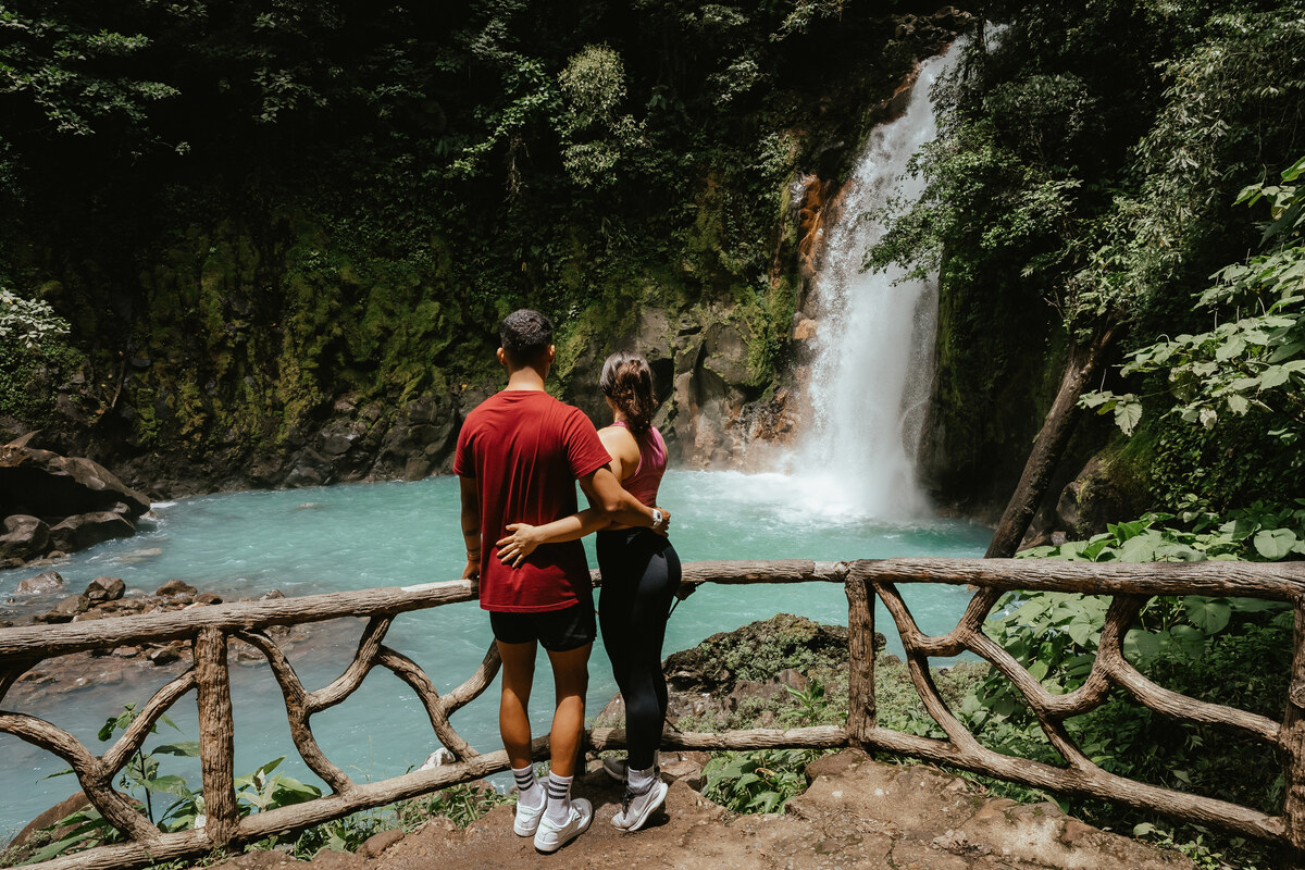 Traveler visiting a rainforest waterfall in Costa Rica