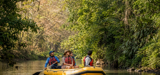 Travelers floating along the Tenorio River on a wildlife tour in Costa Rica