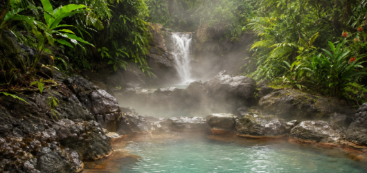Natural rainforest hot springs surrounded by tropical vegetation in Costa Rica